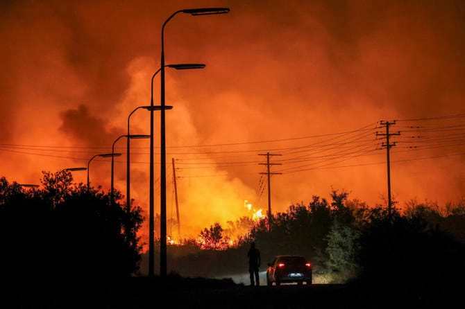 Wildfire rages outside Athens fanned by strong winds