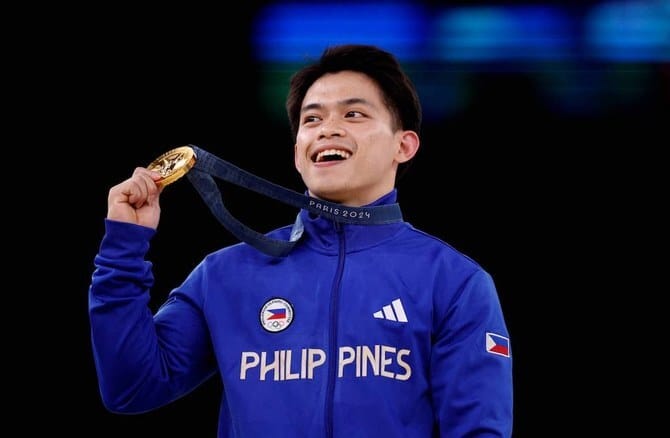 Filipino gymnast who won 2 Olympic golds in Paris gets hero’s welcome and free buffets for life