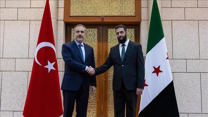 Syria’s new leader says all weapons to come under ‘state control’ in meeting with Turkish FM