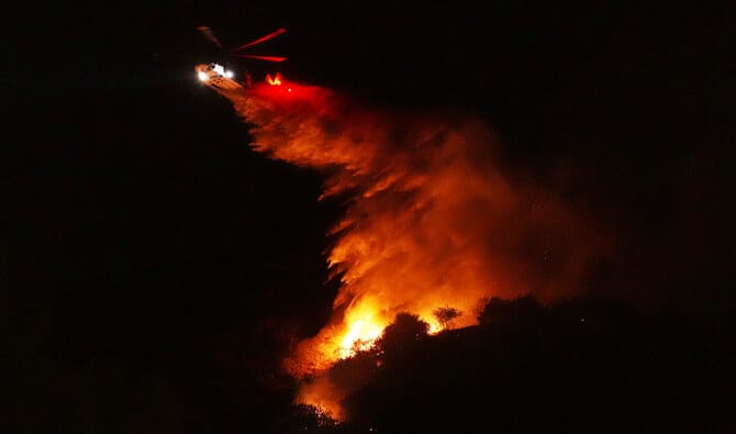 Aerial attack helps firefighters maintain the upper hand on a huge fire north of Los Angeles