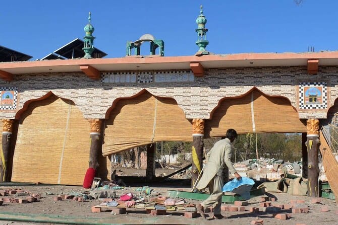 Pakistan holds funeral prayers for 12 people killed in a double suicide bombing near a military base