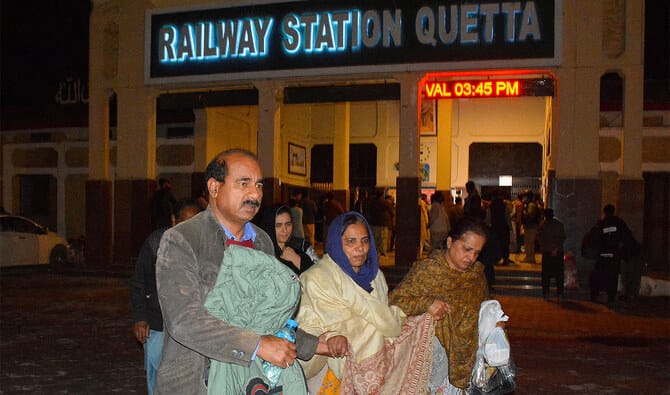 Pakistani security forces battle to free about 300 hostages aboard a hijacked train