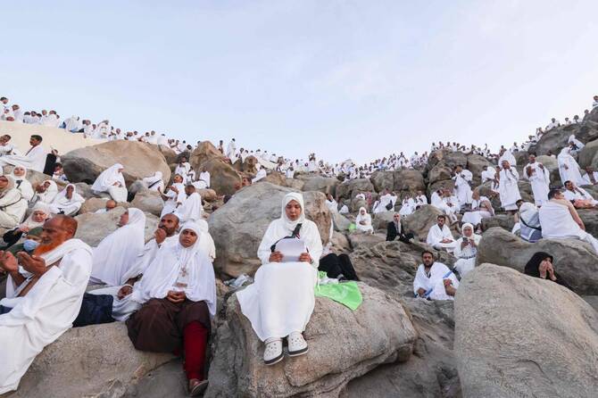 Muslim pilgrims pray at Mount Arafat in Hajj apex