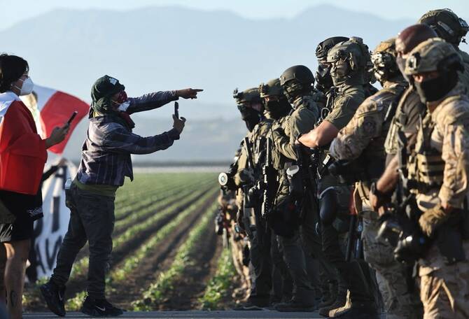Authorities say about 200 immigrants were arrested in raids on 2 Southern California farms
