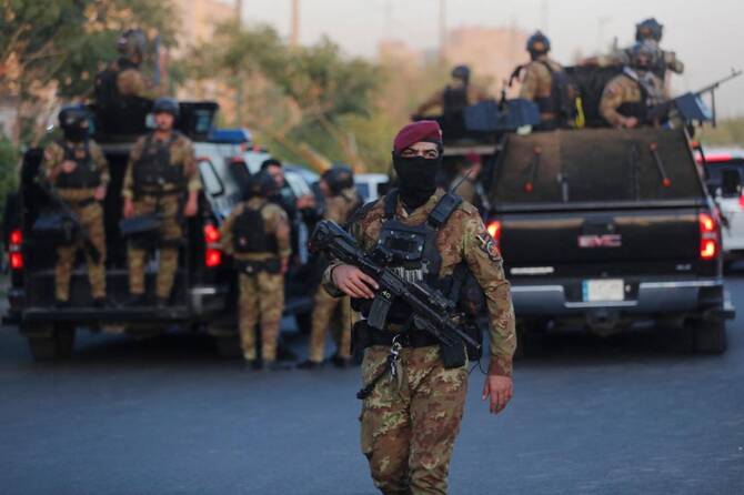 Iraqi police clash with paramilitary fighters who stormed government building