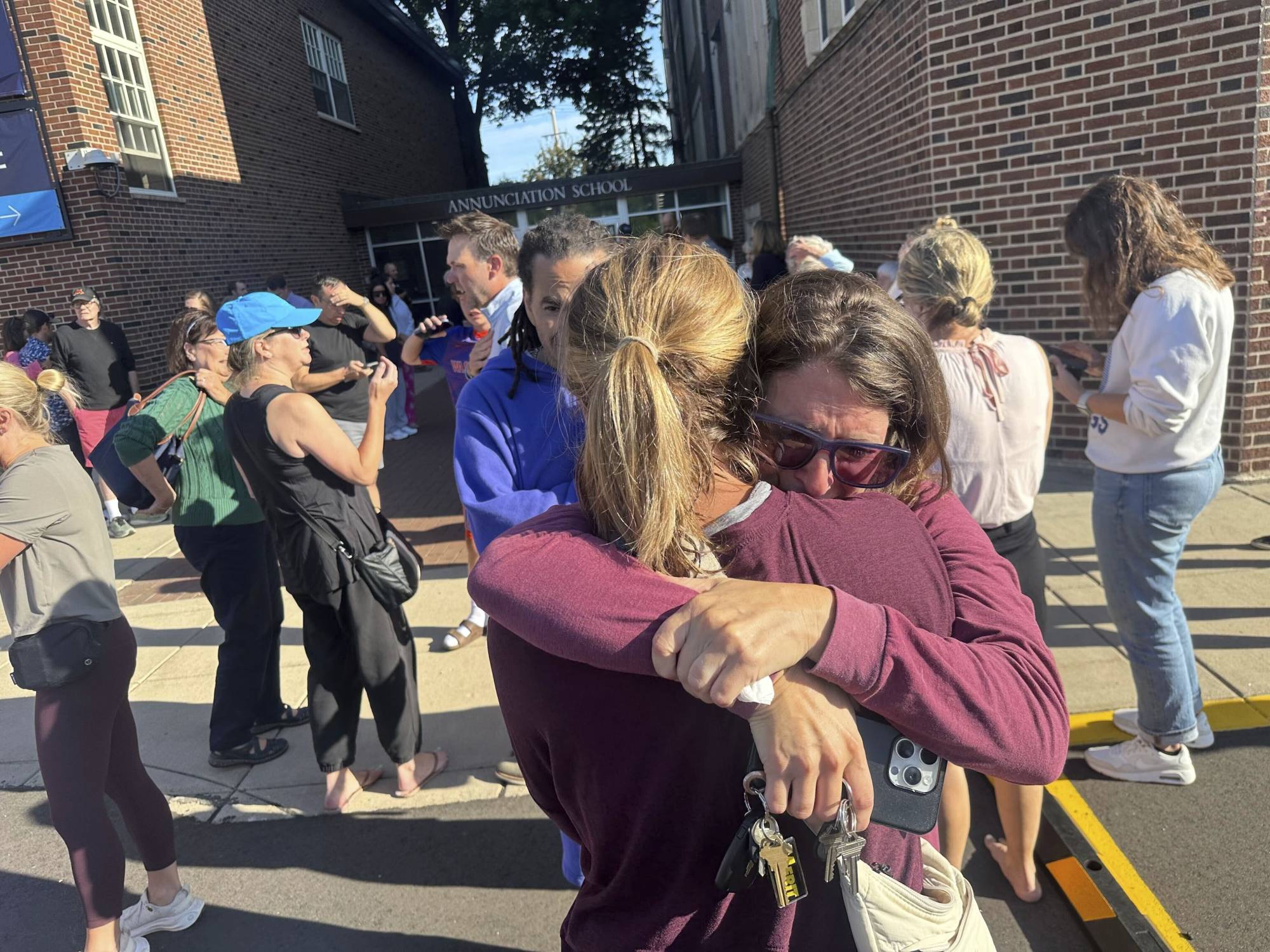 Hundreds honor 2 children killed and 17 people wounded in shooting at a Minneapolis Catholic school