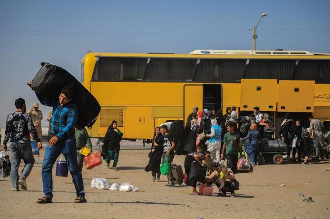 Scores killed after bus carrying returning Afghan migrants hits truck