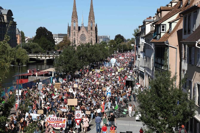 Strikes and protests roil France, pitting the streets against Macron and his new prime minister