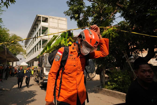 Death toll from Indonesian school collapse rises to 14 as crews pull more bodies from rubble