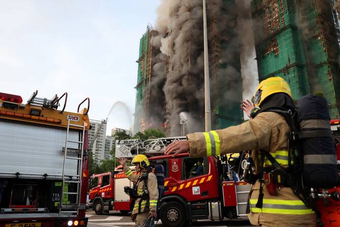 13 people killed in fire engulfing Hong Kong high-rise residential buildings, fire services say